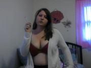 Busty girl smokes and gives a peak 3/16