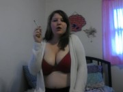 Busty girl smokes and gives a peak 5/16