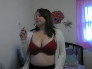 Busty girl smokes and gives a peak 7/16
