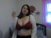 Busty girl smokes and gives a peak 8/16