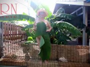 Rural striptease. Country girl dancing in the yard of her house Rustic striptease with banana leaf 11/16