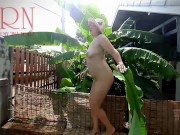 Rural striptease. Country girl dancing in the yard of her house Rustic striptease with banana leaf 13/16