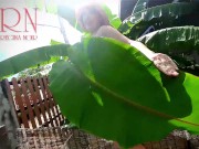 Rural striptease. Country girl dancing in the yard of her house Rustic striptease with banana leaf 9/16
