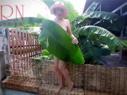 Rural striptease. Country girl dancing in the yard of her house  Rustic striptease with banana leaf 2/16