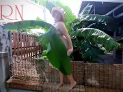 Rural striptease. Country girl dancing in the yard of her house  Rustic striptease with banana leaf 4/16