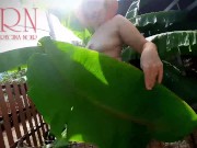 Rural striptease. Country girl dancing in the yard of her house  Rustic striptease with banana leaf 9/16