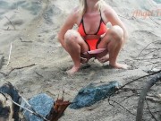 Public peeing teen girl on the beach 10/16