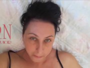 White socks. Cute chick lies on the bed, smiles, gracefully bends. Nice Baby with white socks on th 14/16