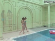 Two hot lesbian brunettes in the swimming pool 2/16