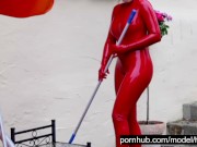 Hot Blonde Girl Works And Piss Outdoor In The Garden In Red Latex Catsuit + Gloves + High Heels 1/16