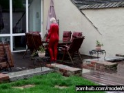 Hot Blonde Girl Works And Piss Outdoor In The Garden In Red Latex Catsuit + Gloves + High Heels 8/16