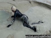 Super Hot Blond Girl In Black Latex Catsuit + High Heels And Sunglasses Bathes In The Mud - Mud Bath 11/16