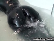 Blonde girl in black rubber catsuit in bathroom relaxes in wet latex and peeing in the bathtub 14/16
