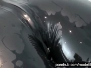 Blonde girl in black rubber catsuit in bathroom relaxes in wet latex and peeing in the bathtub 15/16