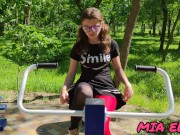 cute smiling schoolgirl walks after school in the city park 5/16
