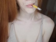redhead girl smokes a cigarette 10/16