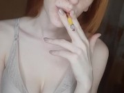 redhead girl smokes a cigarette 12/16
