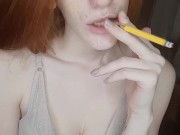 redhead girl smokes a cigarette 4/16