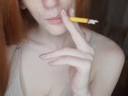 redhead girl smokes a cigarette 9/16