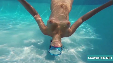 Sexy Candy swims and strips nude underwater