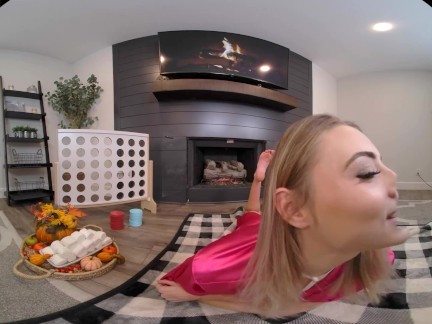 Tiny blonde warms herself up in front of the fireplace with her toy in VR