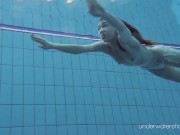 Floating babe in the warm pool getting naked 10/16