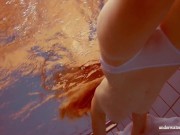 In the indoor pool, a stunning girl swims 11/16