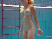 In the indoor pool, a stunning girl swims 14/16