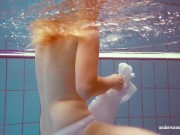 In the indoor pool, a stunning girl swims 8/16