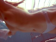 In the indoor pool, a stunning girl swims 9/16